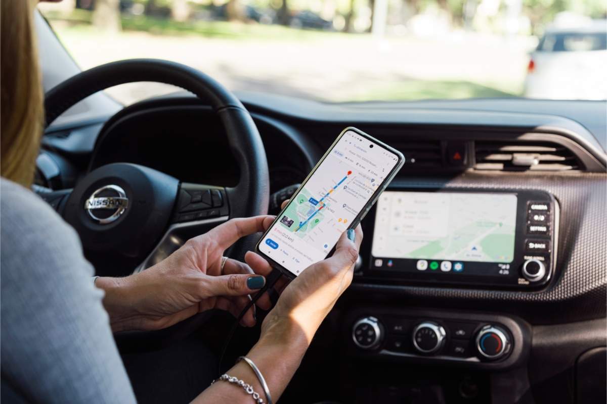 Fahrer sucht in der Google-Maps-App auf dem Smartphone nach Navigationsanweisungen