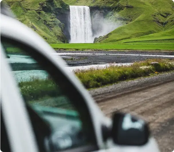 Blick auf den Skógafoss-Wasserfall vom geparkten Auto – Symbol unseres Qualitätsversprechens.
