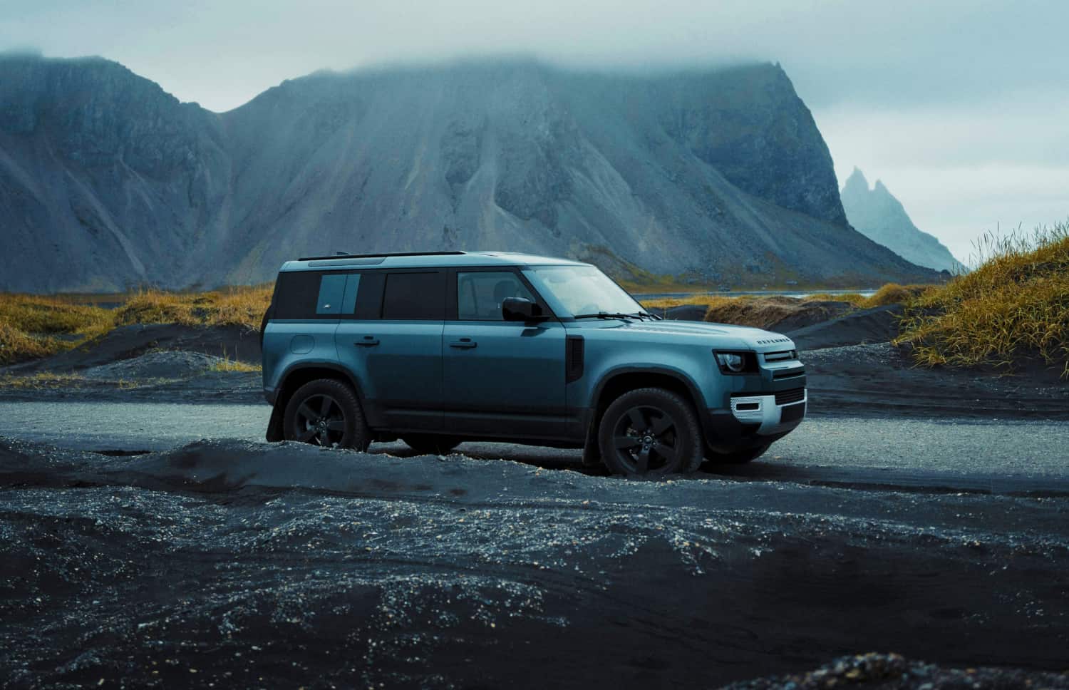 Grauer Land Rover Defender Luxus-4WD-SUV mit GPS, Sitzheizung, USB-Ladegerät und Rückfahrkamera – perfekt für Islands anspruchsvolles Gelände.